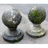 A pair of composition gate posts, of globular form on a stepped base, 45cm high.