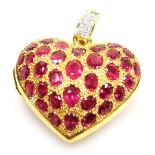 A heart shaped faceted ruby set pierced vinaigrette style locket, pierced back and faceted ruby set