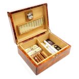 A Hillwood makah burl wood cigar humidor, containing assorted cigars, 30cm wide.