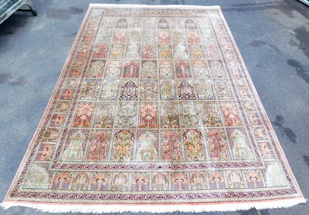 A Persian Heriz cream ground silk rug, with fifty six central panels decorated with tree of life, pl