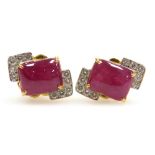 A pair of cushion cabachon ruby and diamond earrings, the central rectangular ruby of 8.7mm x 7mm ed