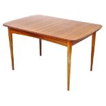 An Austinsuite vintage teak extending dining table, raised on turned legs, brass capped, 63cm high,