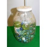 A jar containing various marbles.