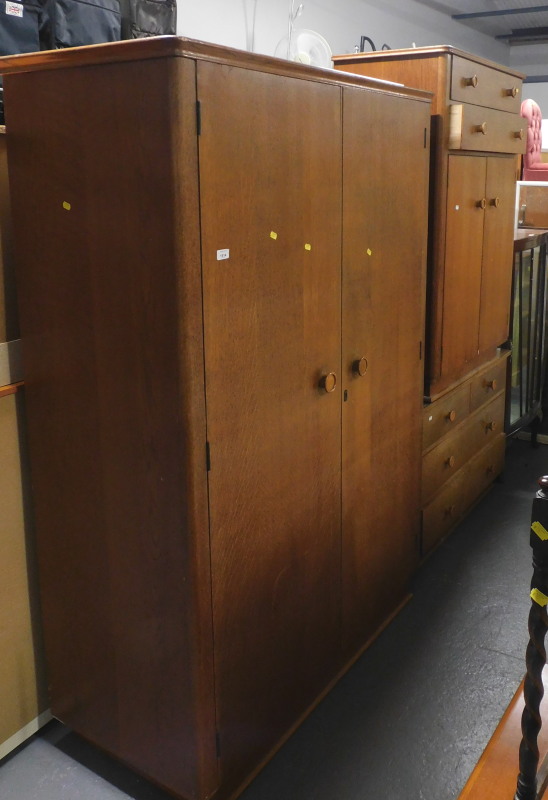 A mid century oak bedroom suite, comprising double wardrobe, a mirror back dressing table, the base