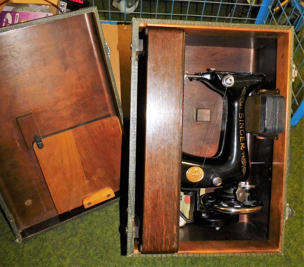 A cased Singer sewing machine.