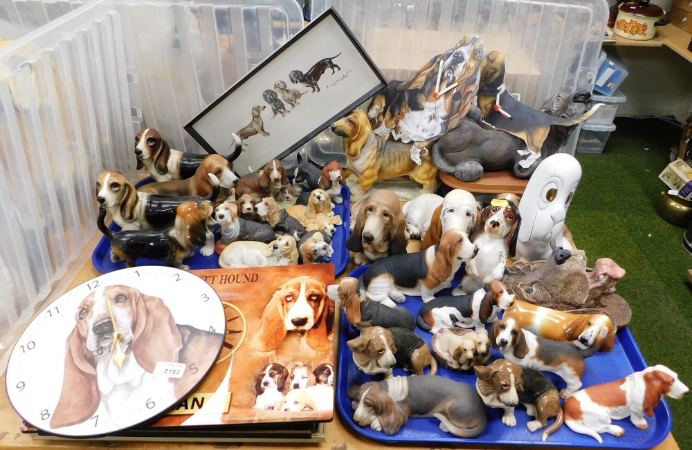 Various dog figures, predominantly Basset Hounds, pottery, and resin examples, novelty wall clocks,