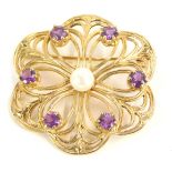 A 9ct gold brooch, formed as a flower, with pierced outer design, set with six amethyst and central