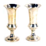 A pair of Edward VII silver fluted vases, each with a fluted rim, on weighted base, Birmingham 1907,