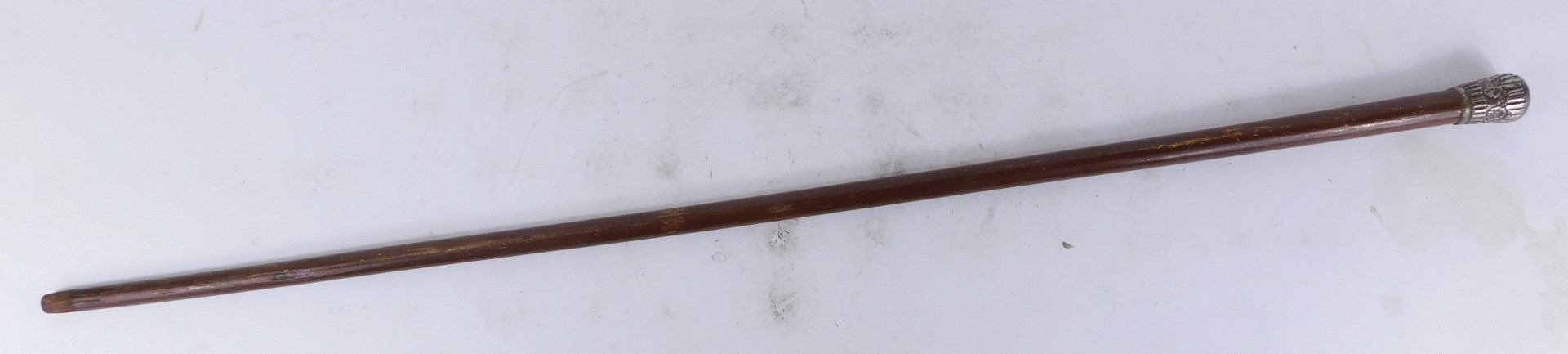 An early 20thC stained pine walking cane, with a plated handle, embossed with flowers, 88cm high. - Image 2 of 2