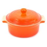 A Le Crueset orange casserole dish, 18cm diameter.