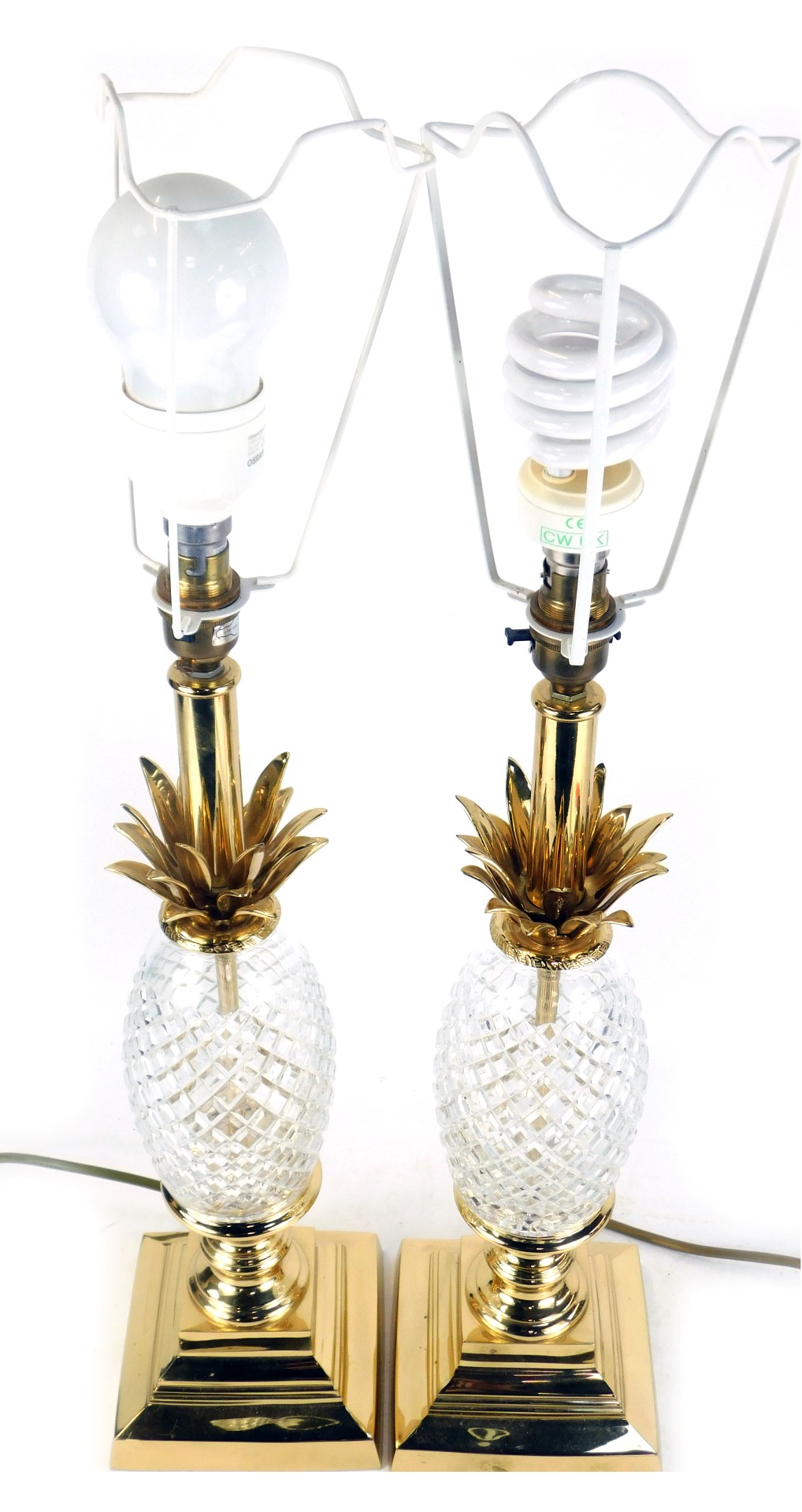A pair of cut glass and brass table lamps, formed as pineapples, on square bases, 65cm high.