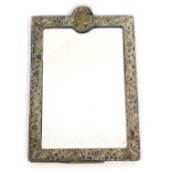 An Edward VII silver mounted strut mirror, of rectangular form, embossed and pierced with rococo scr