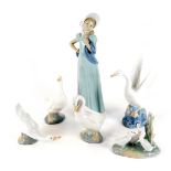 A group of Spanish porcelain figures, comprising geese, and standing lady wearing a bonnet, each wit