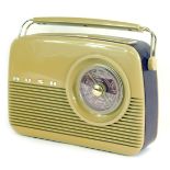 A Bush vintage radio, with a brown Bakelite case, in purple faux leather banding, 27cm high.