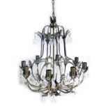 A bronzed finish eight branch chandelier, with crystal droplets and cast with leaves, 50cm high.