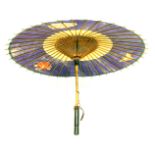 A 19thC Chinese paper parasol with a cream and purple floral border, with black lacquered ends, 62cm