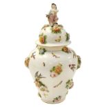 A late 19thC German porcelain jar and cover, of baluster form, the lid with figural boy finial, pain