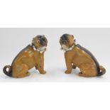 A pair of late 19thC German porcelain models of pugs, each with bells to the collar, number stamped