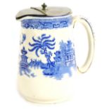 A Gibson & Sons Willow pattern hot water jug, with stainless steel lid, 16cm high.