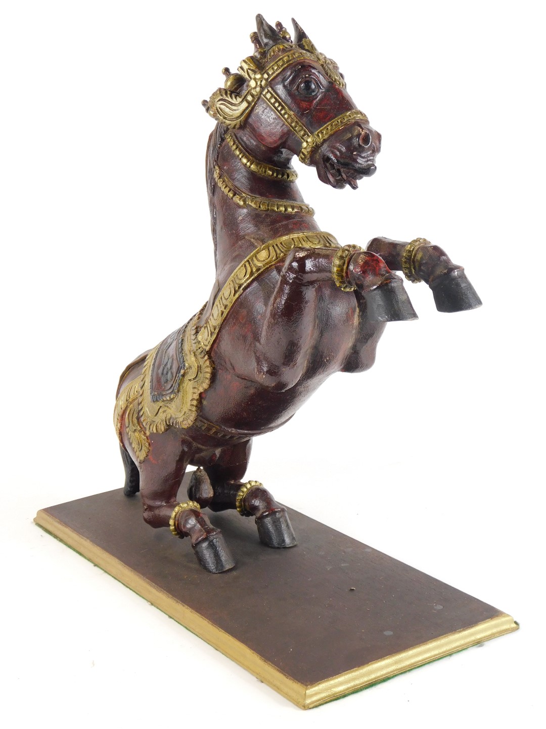 An Eastern hardwood carving of a rearing horse, on a red lacquer painted ground, with gold painted b - Image 2 of 3