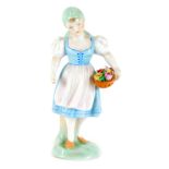 A Herend of Hungary painted porcelain figure, of a girl carrying basket of flowers, 16cm high.