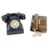 A Siemens of London black Bakelite dial telephone, number for London 87, and a brown wall mounted te