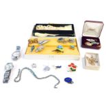 A group of costume jewellery, comprising a floral posy brooch, filigree lily brooch, wristwatches, f