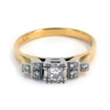 An Art Deco 18ct gold and platinum diamond dress ring, with a stepped and raised diamond set centre,