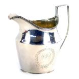 A George III silver cream jug, with a shaped and fluted handle, with Neo Classical wreath, bearing i