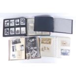 Postcards and photographs, comprising three various postcard albums, each with black and white full