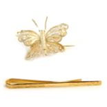 A 9ct gold tie clip, 1.6g, and a filigree white metal butterfly brooch. (2)