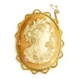 A 19thC shell cameo brooch, the painted imitation cameo depicting a maiden looking right, bearing si