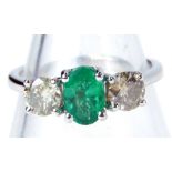 An 18ct white gold emerald and diamond trilogy ring, with round brilliant cut emerald, totaling 0.66