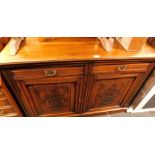A mahogany sideboard, with arrangement of two drawers, and two carved cupboard doors.