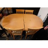 A beech effect twin pedestal dining table, and four chairs. (5)