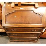 An oak bureau, with three drawers on bracket feet.