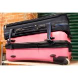 Two suitcases, comprising a pink travel case, a material travel case and a frame. (3)