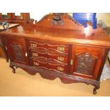 An Edwardian walnut sideboard, with a moulded cornice back above an arrangement of three drawers and