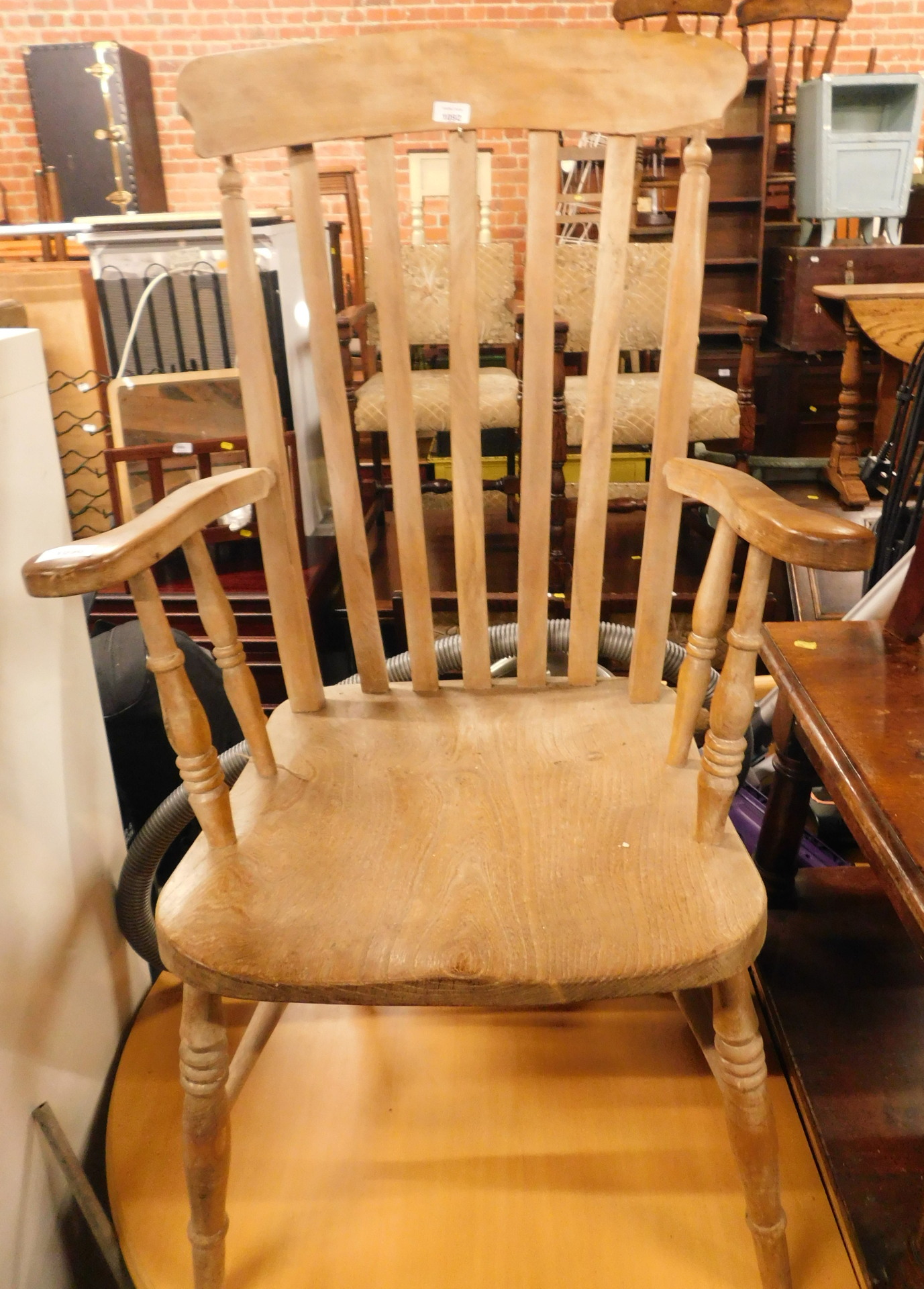 An ash and elm lath back grandfather chair, with shaped arms, 113cm high, 58cm wide.