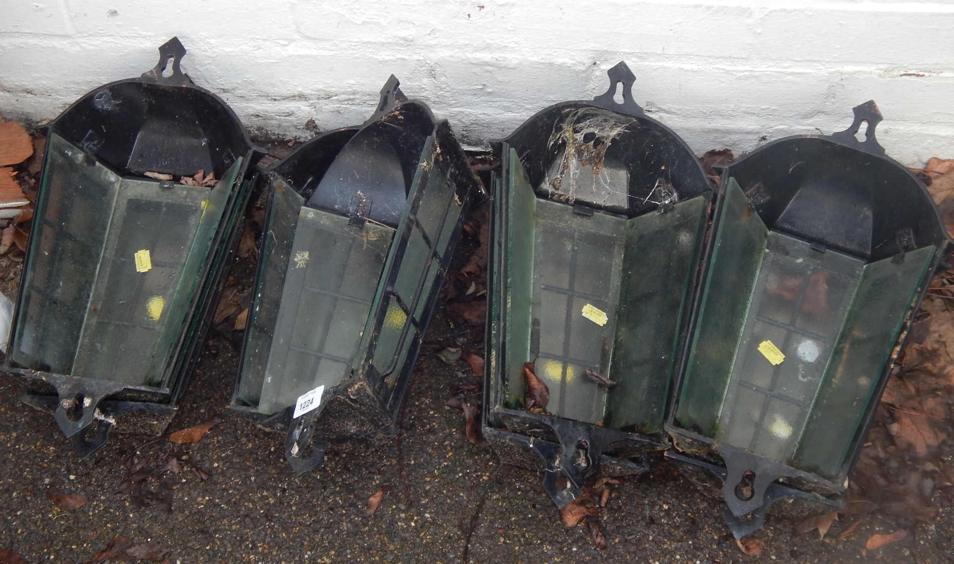 Eight cast metal wall lights, with glass panels.