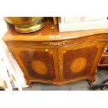 An Italian high gloss parquetry sideboard, with gilt surmounts on out splayed legs.