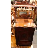 An early 20thC mahogany purdonium, with raised gallery shelf, and cupboard base with carved door, te