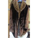 A brown faux fur three quarter length coat.