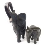 An African tribal figure of an elephant, trunk raised, 51cm high and a further figure of an elephant