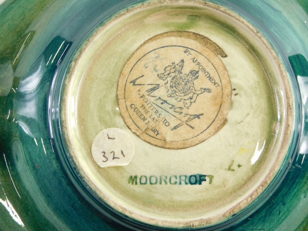 A mid 20thC Moorcroft pottery Orchid pattern ashtray, on green ground, impressed mark with label ben - Image 2 of 2