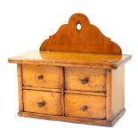 A 19thC fruitwood hanging spice box, with shaped back with four drawers, 19cm high x 19cm wide x 8cm
