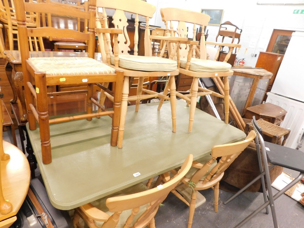 A painted pine refectory style kitchen table, a quantity of beech chairs, and a ladder back chair.