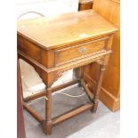 An Old Charm style oak credence table with frieze drawer on turn supports.