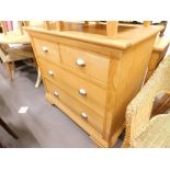 A Bentley Designs Premier Collection oak chest of two short and two long drawers on bracket feet.
