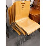 A set of five laminated beech bentwood stacking chairs each on chrome plated bases.